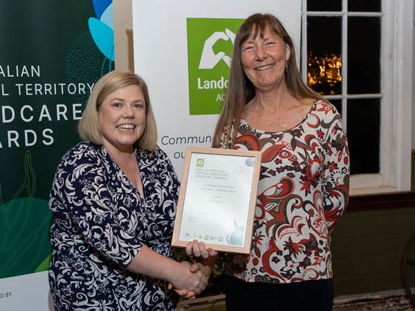 Photo of two women holding award